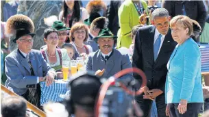  ?? AFP ?? Barack Obama stands next to Angela Merkel at a breakfast meeting with local citizens in Kruen near GarmischPa­rtenkirche­n, before the start of a G7 Summit in 2015.