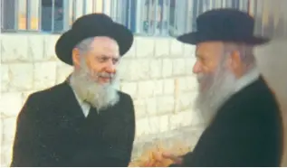  ?? (Wikimedia Commons) ?? RABBI ZVI YEHUDA KOOK (right) – whose father Rabbi Abraham Isaac Kook founded Mercaz HaRav – stands outside the Jerusalem yeshiva with Rabbi Avraham Shapira, who went on to lead the yeshiva, in 1980. Rabbi Zvi Yehuda hung a picture of Herzl in his study next to pictures of the Chofetz Chaim and the Vilna Gaon.