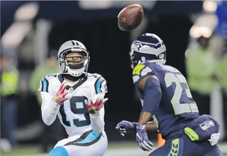  ?? — THE ASSOCIATED PRESS ?? Carolina Panthers’ Ted Ginn reaches for a pass as the Seahawks’ Steven Terrell closes in during Sunday’s game in Seattle. The Seahawks won 40-7.