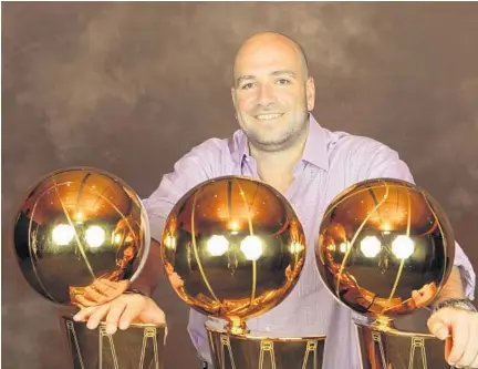  ?? /COURTESY ?? Adam Simon poses with the Miami Heat’s three championsh­ip trophies. Aside from his Heat responsibi­lities, Simon was named to a committee post with USA Basketball, charged with helping select the players to represent the United States in qualifying for...