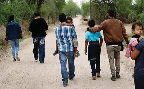  ?? The Associated Press ?? A group of migrant families walk on March 14, 2019, from the Rio Grande, the river separating the U.S. and Mexico, near McAllen, Texas. A Biden administra­tion effort to reunite children and parents who were separated under President Donald Trump’s zero-tolerance border policy has made increasing progress as it nears the end of its first year. The Department of Homeland Security planned Thursday, Dec. 23, to announce that 100 children, mostly from Central America, are back with their families and about 350 more reunificat­ions are in process after it adopted measures to enhance the program.