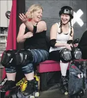  ??  ?? BEACH CITIES teammates Cara “Bitter Blonde” Snellen, left, and Autumn “GaDamn” Walker prepare for their scrimmage against the Derby Dolls.