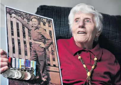  ?? PHOTO: CHRISTINE O’CONNOR ?? Home at last . . . Dunedin resident Kathy Wright holds a photograph of her late brother SAS Corporal Allister (‘‘Buck’’) Buchanan.