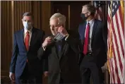  ?? ROD LAMKEY — POOL ?? Senate Majority Leader Mitch McConnell, R-Ky., removes his face mask as he arrives for a news conference in Washington on Tuesday.