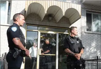  ?? The Canadian Press ?? Police stand guard in front of an apartment building in Montreal on Wednesday. U.S. law enforcemen­t authoritie­s say a man allegedly involved in the stabbing of a police officer at a Michigan airport is a Canadian resident.