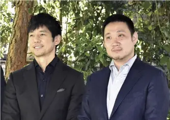  ?? Takamichi Asakawa / The Yomiuri Shimbun ?? Hidetoshi Nishijima, left, and Ryusuke Hamaguchi are seen in Los Angeles on Saturday, ahead of Sunday’s Academy Awards ceremony.