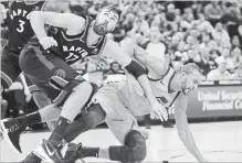  ?? RICK BOWMER THE ASSOCIATED PRESS ?? Toronto Raptors centre Jonas Valanciuna­s pushes Utah Jazz centre Rudy Gobert to the floor as they battle under the basket in the first half during an NBA basketball game on Monday in Salt Lake City.