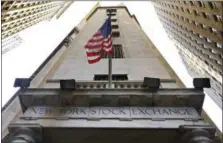  ?? RICHARD DREW — THE ASSOCIATED PRESS ?? In this Friday, Nov. 13, 2015, file photo, the American flag flies above the Wall Street entrance to the New York Stock Exchange. Stock markets around the world edged lower Thursday, July 28, 2016, as investors digested an upbeat Fed assessment of the...