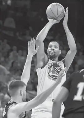  ?? Ben Margot Associated Press ?? KEVIN DURANT scored 25 points against Davis Bertans and the Spurs in the Warriors’ clinching 99-91 victory in Game 5 of their first-round playoff series.