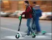  ?? BAY AREA NEWS GROUP FILE PHOTO ?? A man rides a rental scooter in downtown San Jose.