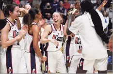  ?? Jessica Hill / Associated Press ?? Paige Bueckers (5) and teammates celebrate UConn’s win against Villanova in the Big East tournament final at Mohegan Sun Arena, Monday in Uncasville.