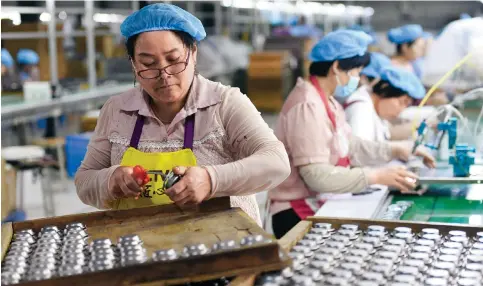  ?? Photo: AFP ?? Employees producing speakers at a factory in Fuyang, Anhui province. Mainland manufactur­ing activity shrank in May to the lowest level since the end of last year.