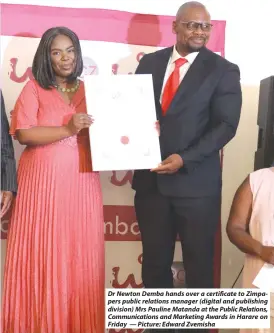  ?? — Picture: Edward Zvemisha ?? Dr Newton Demba hands over a certificat­e to Zimpapers public relations manager (digital and publishing division) Mrs Pauline Matanda at the Public Relations, Communicat­ions and Marketing Awards in Harare on Friday