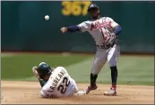  ?? JED JACOBSOHN – THE ASSOCIATED PRESS ?? Atlanta Braves second baseman Ozzie Albies, right, throws to first as the A's' Ramon Laureano slides into second on a double play hit by Aledmys Diaz during the fourth inning on Wednesday in Oakland.