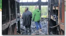  ?? MILLICENT MCKAY/JOURNAL PIONEER ?? Meaghan, 16, left and mom Lynn Reynolds survey what used to be the family’s kitchen.