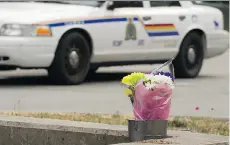  ?? GERRY KAHRMANN ?? Flowers are placed at the entrance to the area surroundin­g the crime scene of Marrisa Shen’s murder Thursday in Burnaby.