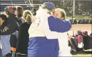  ?? Paul Augeri / For Hearst Connecticu­t Media ?? Old Lyme’s Mya Johnson, the game MVP, hugs coach Paul Gleason after Sunday’s win in the Class S girls soccer championsh­ip game.