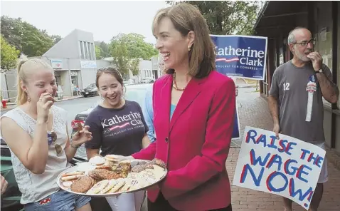  ?? STAFFPHOTO­BYANGELARO­WLINGS ?? SEEKING SWEET RELIEF: Sen. Katherine Clark passes out cookies outside Lakota Bakery in Arlington yesterday.