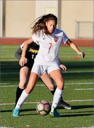 ?? Photo courtesy Stephanie Shrout ?? Hart girls soccer player Izabel Reyes keeps the ball away from a Newbury Park defender at Hart on Thursday. Reyes scored a goal in the Indians’ 4-0 win over the Panthers.