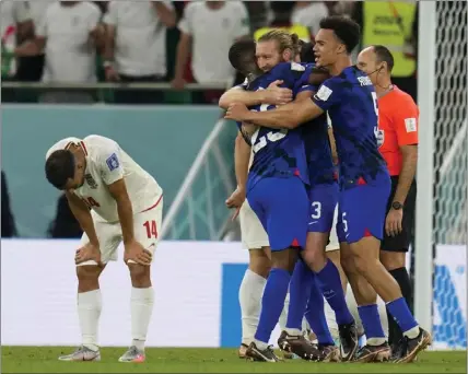  ?? RICARDO MAZALAN — THE ASSOCIATED PRESS ?? U.S players celebrate after their victory over Iran on Tuesday in a World Cup Group B match that sent the Americans to the knockout stage.