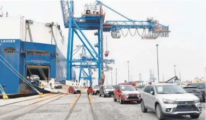  ?? AMY DAVIS/BALTIMORE SUN PHOTOS ?? Subarus roll off the Daedalus Leader, a ship from the NYK Line, based in Tokyo. About half of the 4,937 vehicles on board were discharged in Baltimore. The port of Baltimore is consistent­ly ranked first in the nation in auto imports.