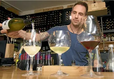  ?? ROSS GIBLIN/STUFF ?? Josh Pointon from Noble Rot wine bar gives some tips and tricks for trying wine.