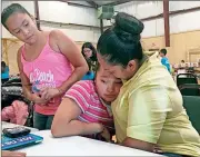  ?? Elliot Spagat /
The Associated Press ?? Marta Rivera consoles her 10-year-old daughter, Santo, who sobbed as her mother described how she became more anxious about being deported since Donald Trump was elected president.