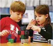  ??  ?? Ed White E-STEM Elementary first-graders Antonio Leal and Gillian Gober build a robot in the library.