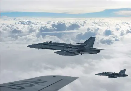  ?? STAFF SGT PERRY ASTON/U.S. AIR FORCE ?? Royal Canadian Air Force CF-18 Hornets, shown over Iraq in October 2014. Canada’s six CF-18s have made 53 of 1,631 airstrikes as part of the internatio­nal coalition to fight ISIL, guided by 70 Canadian special forces troops on the ground training Iraqi...