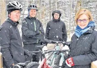  ?? RICHARD MACKENZIE ?? Mark MacNutt (left), Christian Bucher, Thomas Bucher and Janice Bucher from Mountain Bike Trail Builders Pictou County come together on a snowy March morning to talk about work done, and the enjoyment to be had, on the Fitzpatric­k Mountain Trails.