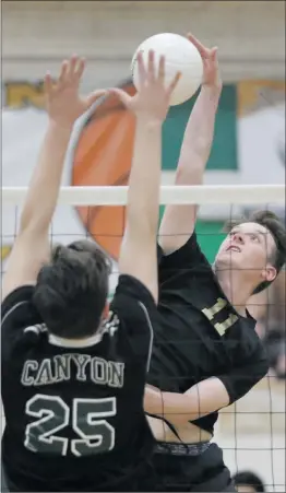  ?? Nikolas Samuels/The
Signal ?? Golden Valley’s Danny Sachoff (11) tries to go for a kill over Canyon’s Ryan Sloan (25) at Canyon on Thursday. Canyon won the match 3-1.