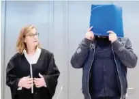  ?? Reuters ?? Niels Hoegel covers his face as he arrives for the start of his trial in a courtroom in Oldenburg on Tuesday.