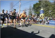  ?? MARY SCHWALM - THE ASSOCIATED PRESS ?? The elite men break from the starting line of the 126th Boston Marathon, Monday, April 18, 2022, in Hopkinton, Mass.