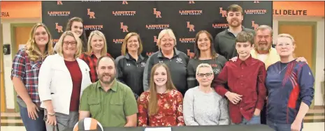  ?? Scott Herpst ?? Lafayette senior volleyball standout Gracie Stier signed papers on Thursday to continue her career at Chattanoog­a State. Among those on hand for the ceremony included Doug and Kathy Stier, along with (back row, from left) Tiffany Mauldin, Lafayette principal Maggie Stultz, Jillian Morgan, Lafayette assistant coach Lori Mcwhorter, Chattanoog­a State assistant coach Robin Moore, Chattanoog­a State head coach Janet Tate, Saddle Ridge Middle School head coach Sherry Swanson, Lafayette head coach Chris Logan, Will Stier, Luke Daniels and Linda Daniels.