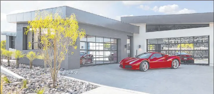  ?? Sun West Custom Homes ?? The 2019 New American Home displayed at the National Associatio­n of Home Builders’ Show in February in Las Vegas features a luxury garage.