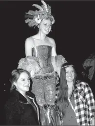  ??  ?? Sammy Macchi (center) of Arkansas Circus Arts poses
for a photo with Aimee Watson and Tricia Barsdale.