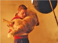  ?? AP FILE PHOTO/MONTGOMERY ADVERTISER/DAVID BUNDY ?? Actor Ewan McGregor (as young Edward Bloom) carries a St. Bernard puppy through a burning house in a scene from the Tim Burton film “Big Fish.”