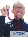  ?? TOBY MELVILLE / REUTERS ?? Yohann Diniz of France poses with his medal after winning the men's 50km walk in London on Sunday.