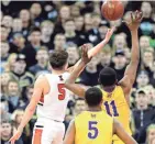  ?? RICK WOOD / MILWAUKEE JOURNAL SENTINEL ?? Kaukauna's Jordan McCabe takes the game-winning layup in front of Milwaukee Washington freshman Michael Foster with just over 2 seconds remaining in the WIAA Division 2 title game.