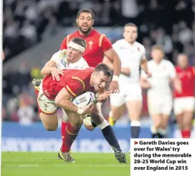  ??  ?? > Gareth Davies goes over for Wales’ try during the memorable 28-25 World Cup win over England in 2015