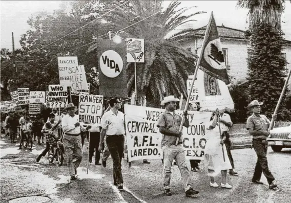  ?? Associated Press file ?? Demonstrat­ors march in 1967 through the streets of Laredo, where Gov. John Connally was in town for a LULAC gathering. The demonstrat­ors said Connally sent Texas Rangers to the Rio Grande Valley to break up worker strikes and accused the law enforcemen­t agency of brutality.