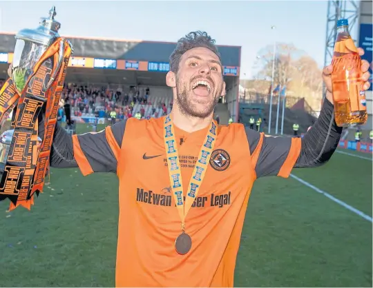  ??  ?? Dundee United’s Tony Andreu celebrates with the trophy after winning the Irn-Bru Cup final at Fir Park