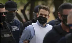  ?? ?? Babis Anagnostop­oulos escorted by police officers in June 2021, when he was charged with Caroline Crouch’s murder. Photograph: Petros Giannakour­is/AP