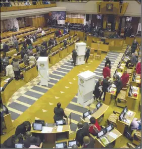  ?? AP PHOTO ?? Members of parliament prepare to vote for or against the motion of no confidence against South African President Jacob Zuma in the South African parliament in Cape Town. South Africa’s main opposition Democratic Alliance party submitted a motion to...