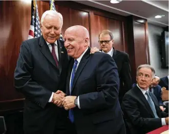  ?? J. Scott Applewhite / Associated Press ?? Tax plan writers Kevin Brady, R-Texas, center, and Orrin Hatch, R-Utah, proclaimed a bill is “close.”