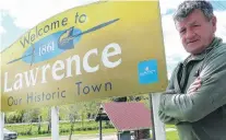  ?? PHOTO: RICHARD DAVISON ?? What’s in a name? . . . LawrenceTu­apeka Community Board member Geoff Davidson, pictured beside the South Otago town’s sign yesterday.