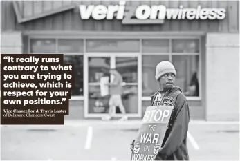  ?? SUCHAT PEDERSON, THE (WILMINGTON, DEL.) NEWS JOURNAL ?? Khalil Andrews shows support for his mother, who works for Verizon, as he pickets a Verizon store in Wilmington. Some picketers have been accused of threatenin­g replacemen­t workers.