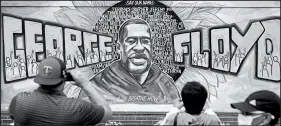  ?? BRIAN PETERSON/STAR TRIBUNE ?? People gather at a memorial mural Friday outside the Cup Foods store on Chicago Avenue in South Minneapoli­s where George Floyd died at the hands of police.