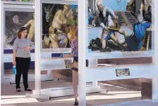  ?? GREG SORBER/JOURNAL ?? Carina Dyer of Albuquerqu­e looks at reproducti­ons of 92 masterpiec­es from the collection of Museo del Prado in Spain on display at Civic Plaza.