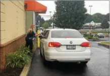  ?? RECORD FILE PHOTO ?? Sgt. Jamie Panichi of the Rensselaer County Sheriff’s Office takes a donation from a drive-through customer at the Dunkin’ Donuts on Hoosick Street in Brunswick during last year’s annual Cop on Top fundraiser for Special Olympics New York.